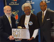 Ms. Naomi King receiving IIPT Plaque from Lou D'Amore and Timothy Marshall