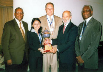 John McAuliff, Executive Director, Fund for Reconciliation and Vietnamese Student delegate receive award on behalf of Peace Trees Vietnam.